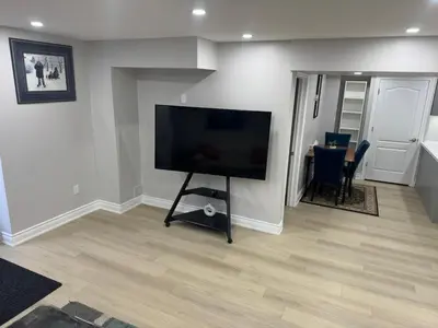 a living room with a large flat screen tv at Blessed Home in Milton
