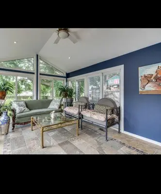 a living room with a couch and a table at Grimsby Lake Front Home in Grimsby