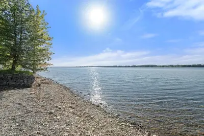 a rocky shore of a large body of water at The Bluebird - 7 Summer Village in Cherry Valley