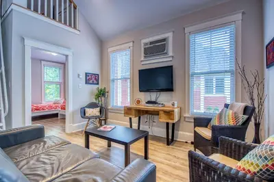 a living room with a couch and a tv at The Bluebird - 7 Summer Village in Cherry Valley