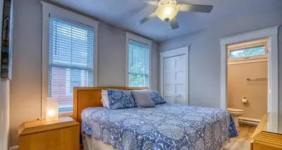 a bedroom with a bed and a ceiling fan at The Bluebird - 7 Summer Village in Cherry Valley