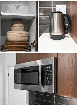 a microwave oven with a kettle on top of it at Basek Apartments in Toronto