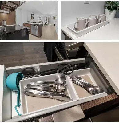 a kitchen sink with silver utensils in it at Basek Apartments in Toronto