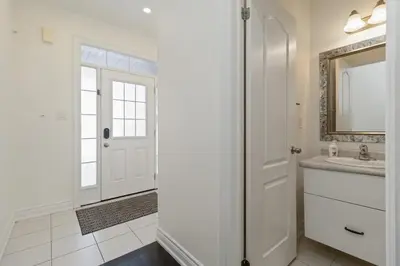 a white bathroom with a sink and a mirror at Serenity Home in Brampton in Brampton