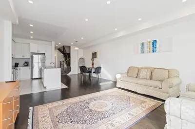 a living room with a couch and a kitchen at Serenity Home in Brampton in Brampton