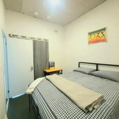 a bedroom with two beds and a table and a window at Feel at home Spacious Industrial Style, 2bed 2bath in Toronto