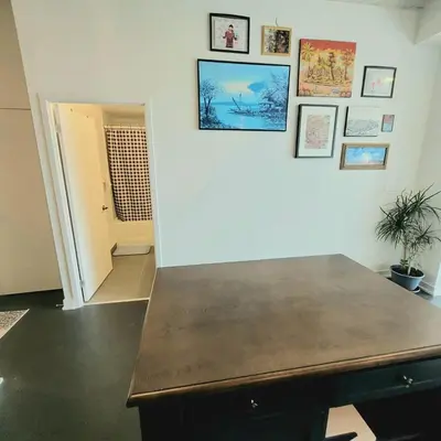 a room with a table and pictures on the wall at Feel at home Spacious Industrial Style, 2bed 2bath in Toronto