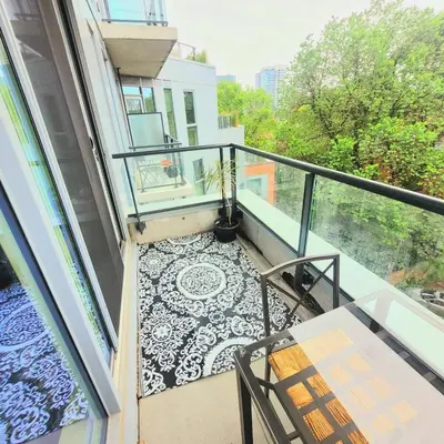 a balcony with a table and a potted plant at Feel at home Spacious Industrial Style, 2bed 2bath in Toronto