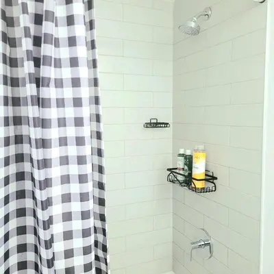a shower with a black and white checkered shower curtain at Feel at home Spacious Industrial Style, 2bed 2bath in Toronto