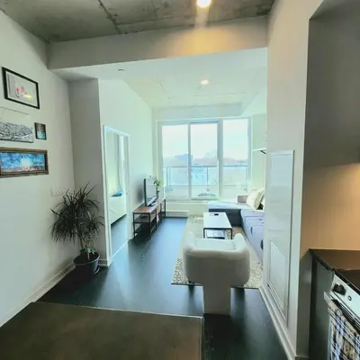 a living room with a couch and a table at Feel at home Spacious Industrial Style, 2bed 2bath in Toronto