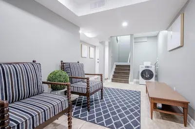 a living room with two chairs and a table at Bright Modern 1BR Suite Kitchen Workspace Smart TV in Bowmanville