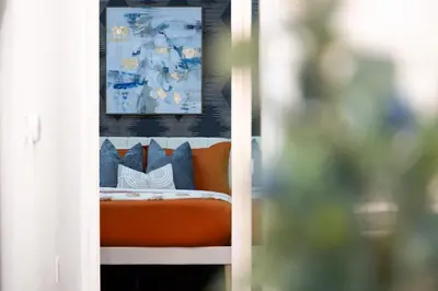 a bed with pillows and a picture on a wall at Lux Harbourfront Home Sleeps 10 with Free Parking in Toronto