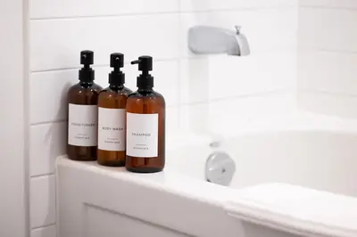 three bottles of wine sitting on a shelf in a bathroom at Lux Harbourfront Home Sleeps 10 with Free Parking in Toronto