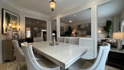 a dining room with a white table and chairs at Executive Luxury Stay Corporate Paradise in South Richvale in Richmond Hill