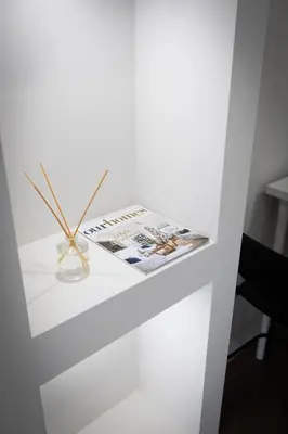 a white shelf with a magazine and a vase on it at Cozy Cove Retreat, Private Suite Near Friday Harbour, Barrie & Lake Simcoe in Innisfil