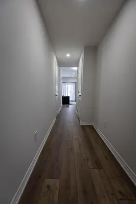 an empty hallway with white walls and wooden floors at Cozy Cove Retreat, Private Suite Near Friday Harbour, Barrie & Lake Simcoe in Innisfil
