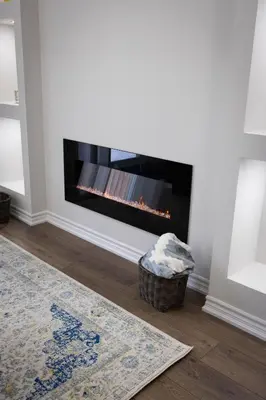 a living room with a fireplace in the wall at Cozy Cove Retreat, Private Suite Near Friday Harbour, Barrie & Lake Simcoe in Innisfil