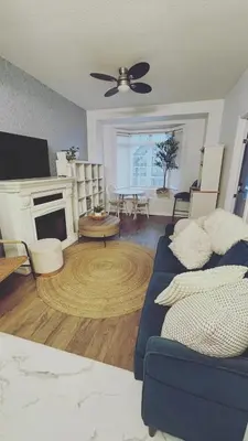 a living room with a blue couch and a fireplace at Grimsby on the Lake sweet, your perfect retreat in Grimsby