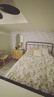 a bedroom with a large bed and a mirror at Grimsby on the Lake sweet, your perfect retreat in Grimsby
