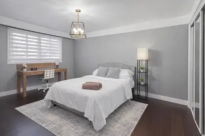 a bedroom with a bed and a desk in it at Executive Urban Retreat in Brampton