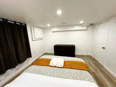 a bedroom with a bed with two towels on it at Modern 2 bedrooms 1 bath updated unit Near Downtown Kitchener & Airport in Kitchener