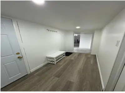 an empty room with a bench and a hallway at Modern 2 bedrooms 1 bath updated unit Near Downtown Kitchener & Airport in Kitchener
