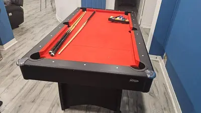 a ping pong table with a red top at A very peaceful home in Oshawa