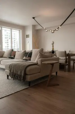 a living room with a couch and a table at Nova Luxury suites in Toronto