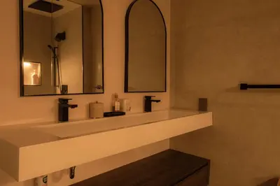 a bathroom with a white sink and a mirror at Nova Luxury suites in Toronto