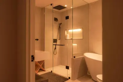 a bathroom with a shower and a toilet and a sink at Nova Luxury suites in Toronto