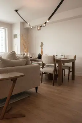 a living room with a couch and a table at Nova Luxury suites in Toronto