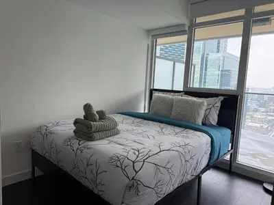 a bedroom with a bed with a teddy bear on it at Luxury Condo Downtown Toronto in Toronto