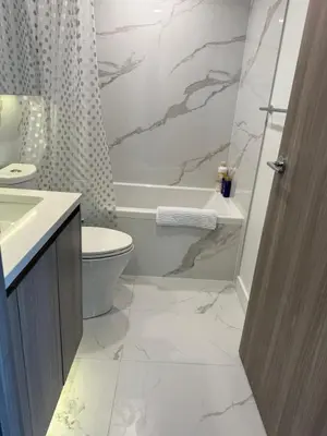 a bathroom with a toilet and a tub and a sink at Luxury Condo Downtown Toronto in Toronto
