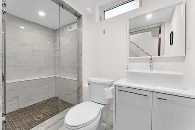 a bathroom with a toilet and a sink and a shower at Winter Deal! Modern 4BR w/Parking, Prime Location in Toronto