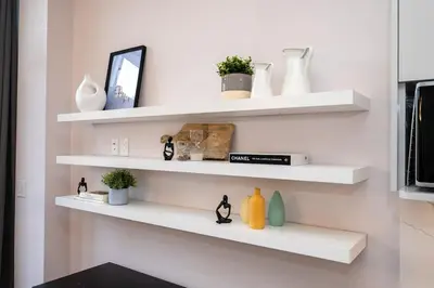 a room with white shelves with vases and plants at Winter Deal! Modern 4BR w/Parking, Prime Location in Toronto