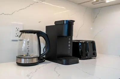 a coffee maker and a blender on a counter at Winter Deal! Modern 4BR w/Parking, Prime Location in Toronto