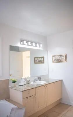 a bathroom with a sink and a mirror at Karibu Home Retreat, 5 min to Ontario Largest Spa in Ajax