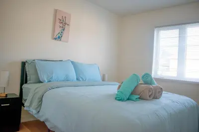 a stuffed animal sitting on top of a bed at Karibu Home Retreat, 5 min to Ontario Largest Spa in Ajax