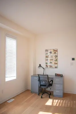 an office with a desk and a chair in a room at Karibu Home Retreat, 5 min to Ontario Largest Spa in Ajax