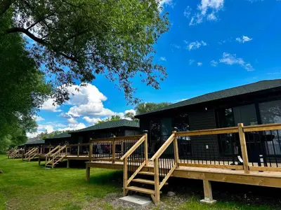 a row of wooden benches in front of a building at Lakeview Willow Bay Cottages in Harwood in Harwood