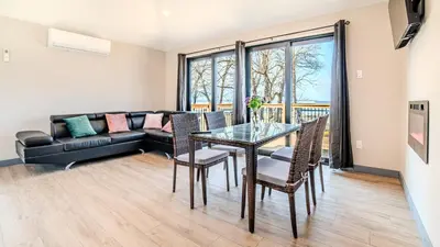 a living room with a table and a couch at Lakeview Willow Bay Cottages in Harwood in Harwood