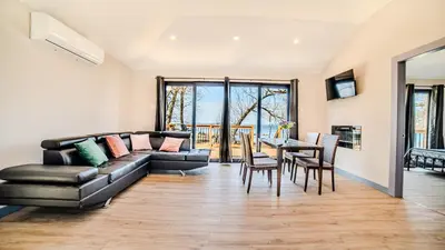 a living room with a couch and a table at Lakeview Willow Bay Cottages in Harwood in Harwood