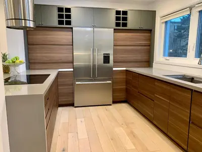 a kitchen with wooden cabinets and a stainless steel refrigerator at Parkside Modern Retreat in Mississauga