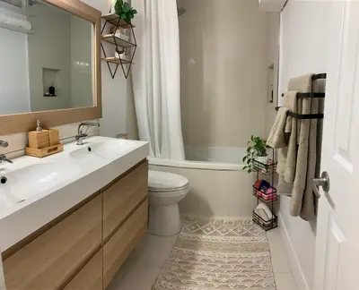 a bathroom with a sink and a toilet and a mirror at Parkside Modern Retreat in Mississauga