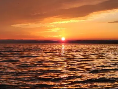 a sunset over a body of water at Getaway by the bay in Owen Sound