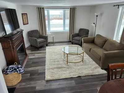 a living room with a couch and a coffee table at Getaway by the bay in Owen Sound