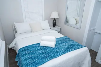 a bedroom with two beds with towels on the bed at Cozy Bungalow Near Niagara Falls - Perfect Family Retreat in Niagara Falls