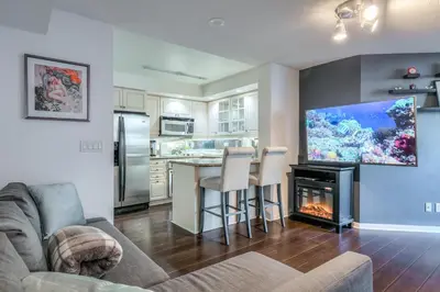 a living room with a fireplace and a tv at Downtown 1BR Condo w/ Balcony & Gym Access in Toronto