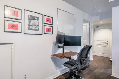 a home office with a desk and a chair at Downtown 1BR Condo w/ Balcony & Gym Access in Toronto