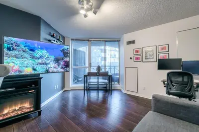 a living room with a large fish tank on the wall at Downtown 1BR Condo w/ Balcony & Gym Access in Toronto